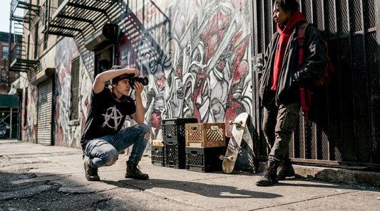 Photographer shooting streetwear on gritty city sidewalk