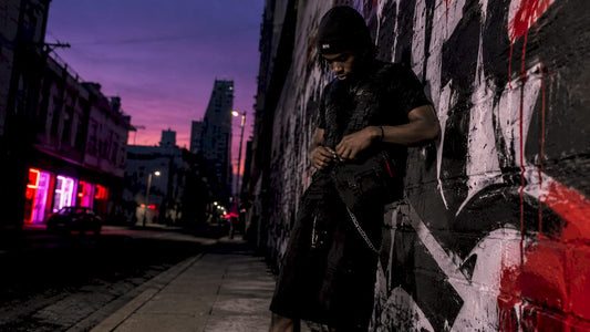 Young man wearing tactical streetwear on rooftop
