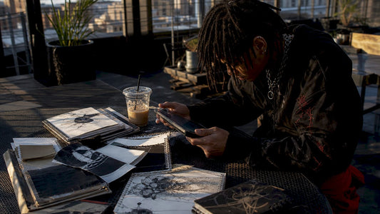 Person browsing custom streetwear on tablet at home