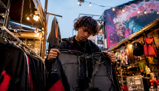 Young adult browsing sustainable streetwear hoodie in boutique